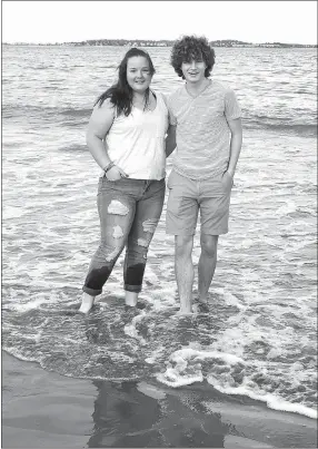  ?? SUBMITTED ?? With the city of Boston and Boston Harbor as a backdrop, Decatur natives Cameron Shaffer (left) and brother Ryan take a quiet walk along a beach near Quincy, Mass., in late May. After living nine months in the Medford-Boston area, Ryan returned to...