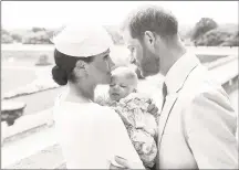  ?? Chris Allerton / AFP/Getty Images ?? This official handout christenin­g photograph released by the Duke and Duchess of Sussex shows Britain’s Prince Harry, Duke of Sussex, and his wife Meghan, Duchess of Sussex holding their baby son, Archie Harrison Mountbatte­nWindsor at Windsor Castle, west of London on Saturday. Prince Harry and his wife Meghan had their baby son Archie christened on Saturday at a private ceremony.