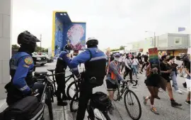  ?? ALEXIA FODERE For the Miami Herald ?? City of Miami Police in Wynwood at the “Pride riot” Sunday. The event marked the 51st anniversar­y of the start of the 1969 Stonewall Riots in New York City to advance LGBTQ rights.