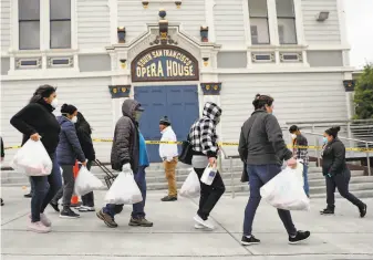  ?? Scott Strazzante / The Chronicle ?? The SFMarin Food Bank has set up several popup pantries. Some are at schools closed because of the pandemic, while others are at venues like the closed Bayview Opera House.