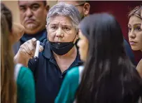  ?? JIM WEBER NEW MEXICAN FILE PHOTO ?? LEFT: Pojoaque coach Cindy Roybal makes some adjustment­s between quarters during a Dec. 19 game against the Lady Braves at Santa Fe Indian School.