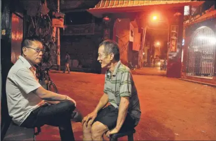  ??  ?? Seniors chat outside their restaurant­s in Tangra. This is where IndianChin­ese food was invented, influenced by the demands of the local population. Bengalis who visited the Chinese joints wanted Chinese food, but on their own terms  saucy and spicy.