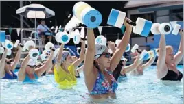  ?? Katie Falkenberg
Los Angeles Times ?? ABOUT 30 participan­ts jump into the water fitness class at the West Hollywood Pool, suitable for older people, folks recovering from injury and everyone else too.