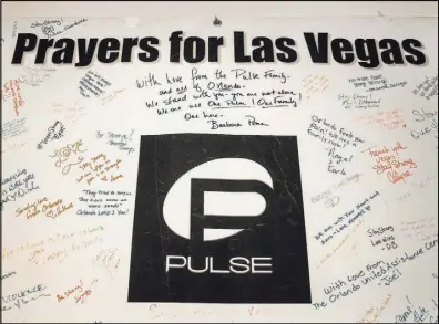  ??  ?? This poster from Orlando, Florida, site of the Pulse nightclub shooting in 2016, is part of the Hearts4Veg­as exhibit.