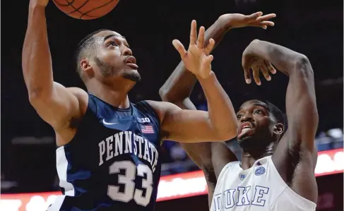  ??  ?? Penn State’s Shep Garner looks to shoot over Duke’s Isaiah Washington in the Hall of Fame Tip- Off Tournament in Uncasville, Conn. | JESSICA HILL/ AP