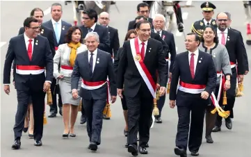  ??  ?? PVizcarra (second right) accompanie­d by his cabinet walks to the Congress during celebratio­ns of Independen­ce Day in Lima, Peru. — Reuters photo