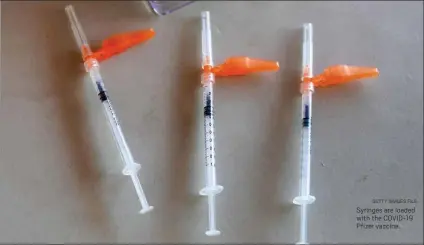  ?? GETTY IMAGES FILE ?? Syringes are loaded with the COVID-19 Pfizer vaccine.