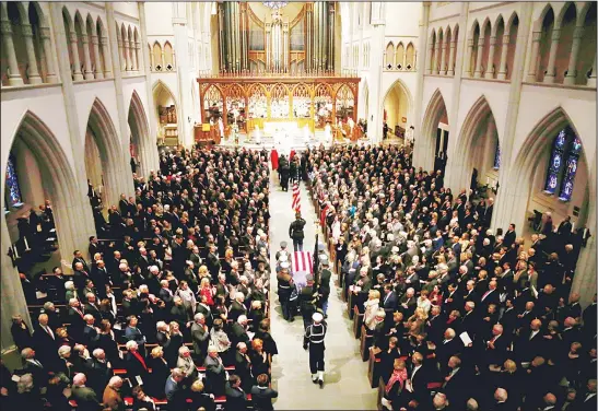  ??  ?? The flag-draped casket of former President George H.W. Bush is carried by a joint services military honor guard into St Martin’s Episcopal Church on Dec 6, in Houston. (AP)