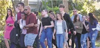  ?? MICHELE EVE SANDBERG/ AFP/ GETTY IMAGES ?? Right after the shooting at Marjory Stoneman Douglas High School in Parkland, Fla., the focus was on grieving. But with students returning to class, the mind- set of many has shifted to protection.