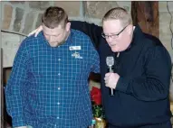  ?? Bud Sullins/Special to the Herald-Leader ?? Greg Baskin (right) prays with Dustin’s Dream’s new director, Chris Borkert (left) at the event.