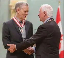  ?? CANADIAN PRESS FILE PHOTO ?? Author and humourist Stuart McLean is presented with the Officer of the Order of Canada medal by Gov. Gen. David Johnston in Ottawa in September 2012.