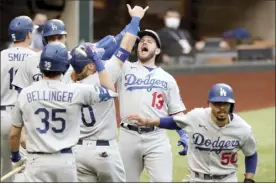  ?? Atlanta Journal-Constituti­on via AP ?? The Dodgers’ Max Muncy celebrates his grand slam with teammates during the first inning of Los Angeles’ 15-3 victory over the Atlanta Braves in Game 3 of the NLCS on Wednesday.