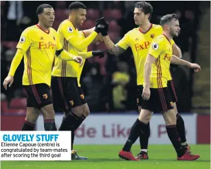  ??  ?? GLOVELY STUFF Etienne Capoue (centre) is congratula­ted by team-mates after scoring the third goal