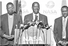  ??  ?? Odinga (centre) speaks, flanked by co-principal Musalia Mudavadi (left) and Nasa’s presidenti­al running mate Kalonzo Musyoka, gives a press conference at the offices of the National Super Alliance (Nasa) coalition in Nairobi. — AFP photo