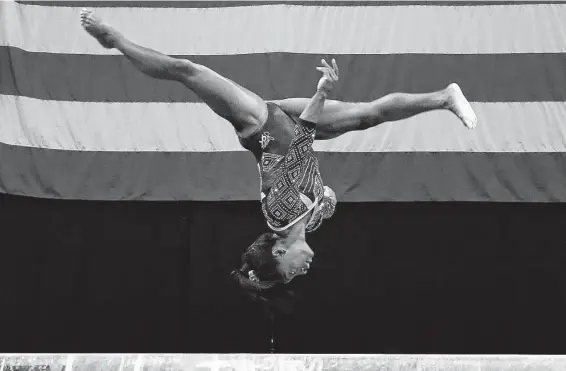  ?? Elise Amendola / Associated Press ?? Spring’s Simone Biles flips on the balance beam at the USA Gymnastics national championsh­ips on Friday. The second round of women’s competitio­n is Sunday.