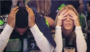  ?? DAVID RYDER/GETTY IMAGES ?? Seattle Seahawks fans can’t bear to watch as their team loses the Super Bowl to the New England Patriots on Sunday. Sport nowadays seems more than just a simulation of life but, for many, life itself.
