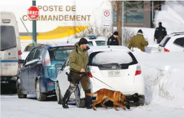  ?? (Mathieu Belanger/Reuters) ?? POLICE OFFICERS patrol the perimeter at the scene of a fatal shooting at the Quebec Islamic Cultural Center yesterday.