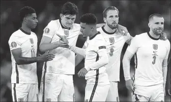  ?? AFP ?? England forward Jadon Sancho (center) is consoled by teammates after missing his penalty during the shootout in Sunday’s Euro 2020 final against Italy.