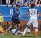  ?? PETER MCCABE — THE CANADIAN PRESS ?? Montreal Impact’s Raheem Edwards, centre, weaves his way around the Union’s Alejandro Bedoya, left, and Auston Trusty during first-half action Saturday in Montreal. The Union won a rare road game over the Impact.