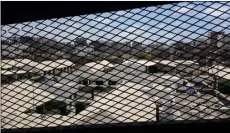  ??  ?? This 2017 file photo, shows a view through a mesh window over part of Aden Central Prison, known as Mansoura, in Aden, Yemen. AP PhoTo/MAAD EL ZIkry