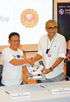  ??  ?? DR. TORRES and Mr. Solomon Juada Jr., Globe’s Cluster Sales Head for Field Sales Operations for Mindanao seal the partnershi­p with a handshake at the signing of the memorandum of conferment yesterday.