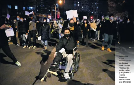  ?? ?? Asistentes a una manifestac­ión en Beijing, ayer, por las víctimas de un incendio, y en protesta contra las duras restriccio­nes por el Covid-19.