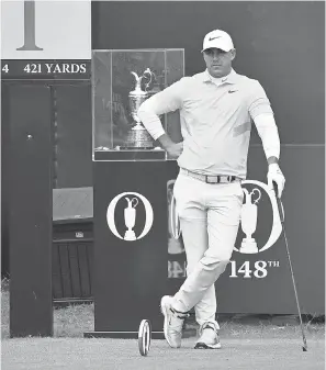  ??  ?? Brooks Koepka stands in front of the Claret Jug trophy on the first tee during the final round of the British Open. STEVEN FLYNN/USA TODAY SPORTS