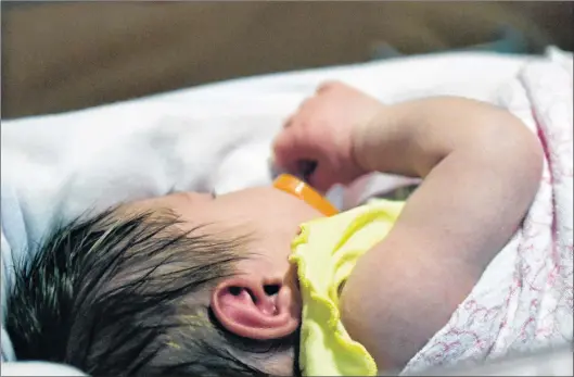  ?? AP PHOTO ?? A week old baby lies in one of the ICU bays at one of the Norton Children’s Hospital neonatal intensive care units Tuesday, Feb. 13, 2018, in Louisville, Ky.