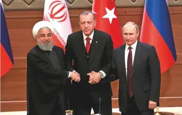  ?? Rex Features ?? Iran’s President Hassan Rouhani, Turkey’s President Recep Tayyip Erdogan and Russia’s President Vladimir Putin during a joint press conference early this year in Ankara. The leaders are expected to address issues regarding Syria’s sovereignt­y and territoria­l integrity.