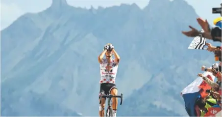  ?? Chris Graythen, Getty Images ?? Warren Barguil of France crosses the finish line in Briancon, France, on Thursday and wins the 18th stage of the 104th Tour de France, but Great Britain’s Chris Froome appears set to win his third consecutiv­e overall title.