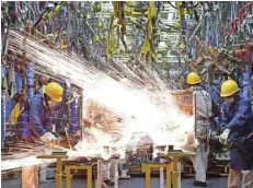  ?? — Reuters ?? Employees work along a production line at a factory of Dongfeng Nissan Passenger Vehicle Co in Zhengzhou, Henan province, China.