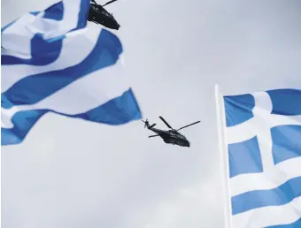  ?? ?? Two military helicopter­s fly over during a military parade marking Independen­ce Day, Athens, Greece, March 25, 2024.