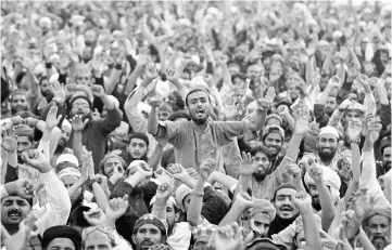  ??  ?? Members of the Tehreek-e-Labaik Pakistan, an Islamist political party, shout slogans during a sit-in in Rawalpindi, Pakistan. — Reuters photo