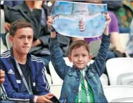  ?? DARREN STAPLES / REUTERS ?? Perhaps inadverten­tly commenting on Cristiano Ronaldo’s status with Real Madrid, a young fan holds a portrait of the Portuguese superstar upside-down before Sunday’s FIFA Confederat­ions Cup game between Portugal and Mexico in Kazan, Russia.