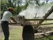  ?? LISA SCHEID — READING EAGLE ?? Cori Putt, a retired auto mechanic from Robesonia, is a volunteer collier carrying on an old process at Hopewell Furnace National Historical Park in which wood is heated to make coal. The charcoal pit is fired up once a year and takes two weeks. Volunteers tend the pit 24hours a day.