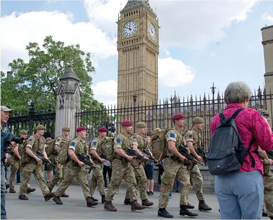  ??  ?? Show of strength: Armed forces patrol on the streets outside Parliament, which was closed to the public yesterday