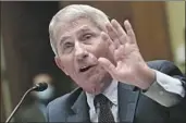  ?? Kevin Dietsch Associated Press ?? ANTHONY FAUCI, the top U. S. infectious disease expert, is now a punching bag for the president.