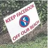  ??  ?? A sign expressing opposition to a Facebook plan to build a landing spot for a cable.