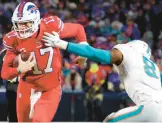  ?? TIMOTHY T LUDWIG/GETTY ?? The Dolphins will have to limit Bills quarterbac­k Josh Allen, left, from running all over their defense, as he did in their last meeting on Dec. 17.