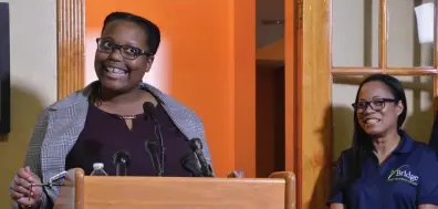  ?? CHRIS CHRISTO/ HERALD STAFF ?? HOME SWEET HOME: New resident Jessica Freeman speaks at the opening of Liberty House, an apartment for homeless youths, as Bridge Over Troubled Waters Executive Director Elisabeth Jackson looks on. The 10-bedroom co-op style housing in Dorchester will help teens and young adults, courtesy of a $1.1 million gift from the Liberty Mutual Foundation.