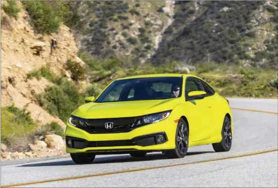  ?? PHOTOS COURTESY HONDA ?? In addition to being able to enjoy the extra control the Civic’s six-speed standard transmissi­on allows, there are some other items new for 2020. A mild refreshing adds a new grille, revised front and rear bumpers, and different headlights and fog light trim.