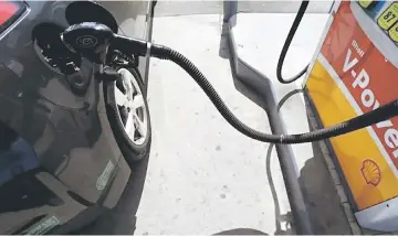  ??  ?? A car is filled with gasoline at a gas station pump in Carlsbad, California. — Reuters photo