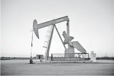  ?? — Reuters photo ?? A pump jack operates at a well site leased by Devon Energy Production Company near Guthrie, Oklahoma.
