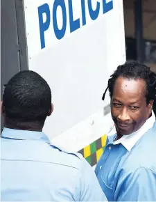  ??  ?? Michael McLean is being escorted from the Supreme Court, downtown Kingston, on Thursday.