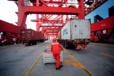  ??  ?? A worker is seen at the Yangshan Deep Water Port, part of the Shanghai Free Trade Zone, in Shanghai, China. Regional policy experts see increased protection­ism and trade wars as the top risks to growth in the Asia-Pacific. — Reuters photo