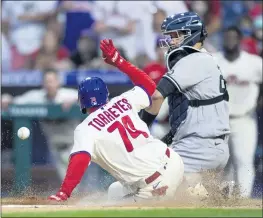  ?? LAURENCE KESTERSON — THE ASSOCIATED PRESS ?? Philadelph­ia’s Ronald Torreyes scores the winning run on an infield single by Jean Segura before New York Yankees catcher Gary Sanchez can catch the ball in the 10th inning Saturday.