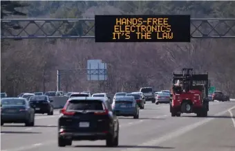  ?? NANCY LANE / HERALD STAFF ?? TODAY’S THE DAY: A sign reminding motorists about the new hands-free phone law going into effect today is seen on Route 128 last week.