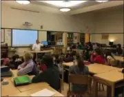  ??  ?? John Gray speaks to students at Woodland Hill Montessori School.