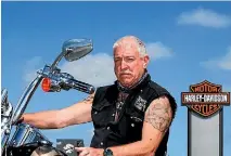  ?? PHOTO: WARWICK SMITH/FAIRFAX NZ ?? Harley Owners Group central districts chapter director Graeme Mills outside ANZA motorcycle­s on Taonui St.
