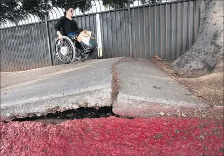  ?? Photog raphs by Mark Boster
Los Angeles Times ?? CATALINA MORGAN’S COMMUTE turns into a tricky maze as she navigates her wheelchair over the broken sidewalks along East Cesar Chavez Avenue in downtown Los Angeles. The walkways will be eligible for repairs within a few years, according to city plans.